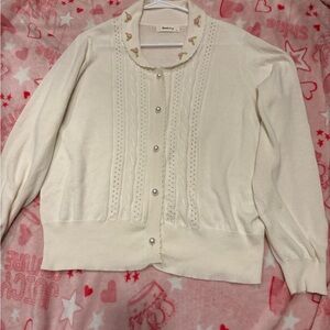 Cream cardigan with shawl collar and pear and rose detail
